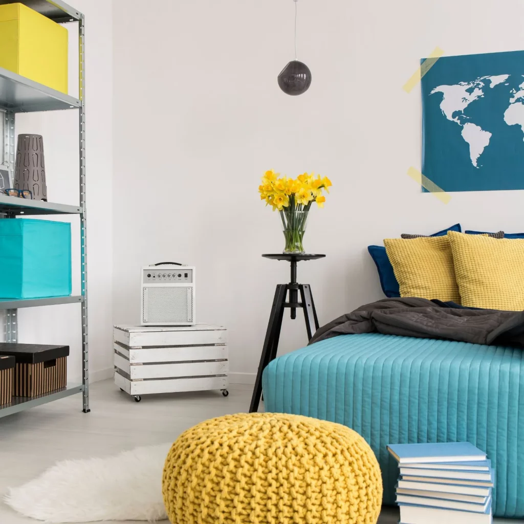 A blue and yellow bedroom - feature image for bedroom essentials list post